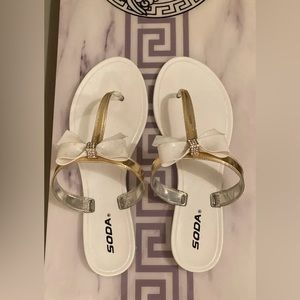 White and gold flip flops